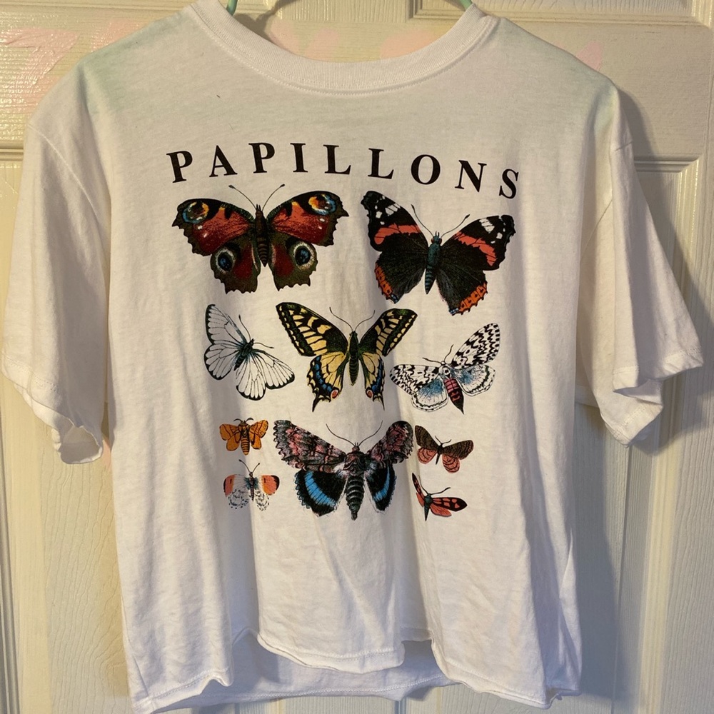A white t shirt with butterflies